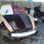 Before and after photographs of a damaged Porsche that was repaired by Elite Paint & Body Shop in West Palm Beach, Florida.